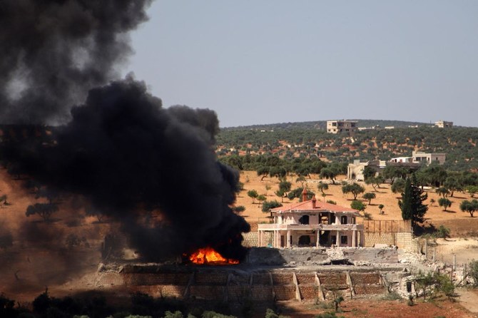 A plume of smoke rises from a building following a reported Russian air strike on Syria's northwestern rebel-held Idlib province, on June 25, 2023. The strikes killed at least seven people, including four civilians, in retaliation for deadly drone attacks blamed on rebel forces, a war monitor said. (AFP)