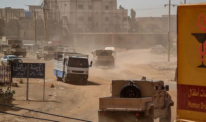 Sudanese army armored vehicles drive in a street in Khartoum, on June 26, 2023. Sudan’s army today faced a multi-front challenge after losing a Khartoum police headquarters to paramilitaries in a battle that killed at least 14 civilians, while rebels attacked troops. (AFP)