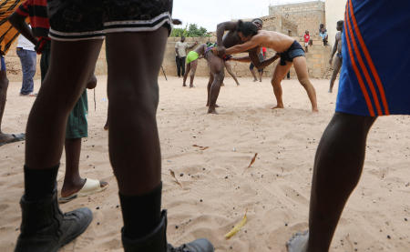 Shogo Uozumi, known as Songo Tine, 29 years old, engages in a wrestling match against Ahmed Diop at the Samba Dia stable in the Diakhao neighbourhood, Thies, Senegal, May 26, 2023. (Reuters)