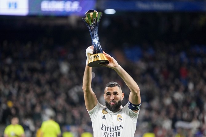 Karim Benzema holds up the FIFA Club World Cup trophy. In June, he joined Al-Ittihad of Jeddah, where the next Club World Cup will be held. (AP)