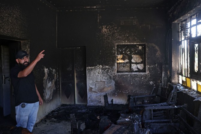 A Palestinian gestures inside his home, which was set on fire by Israeli settlers the day before, in Turmus Aya near Ramallah, on June 22, 2023. (AFP)