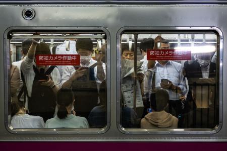 Commuters travel on a train in Tokyo on June 8, 2023. (AFP)