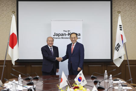 In this photo provided by Japan's Finance Ministry, Japanese Finance Minister Shunichi Suzuki (left) and South Korea's Economy and Finance Minister Choo Kyungho shake hands as they pose for a photo before their meeting at the finance ministry in Tokyo, Thursday, June 29, 2023. (AP)