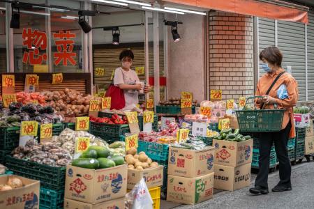 People shop at a supermarket in Tokyo on June 23, 2023. (AFP)