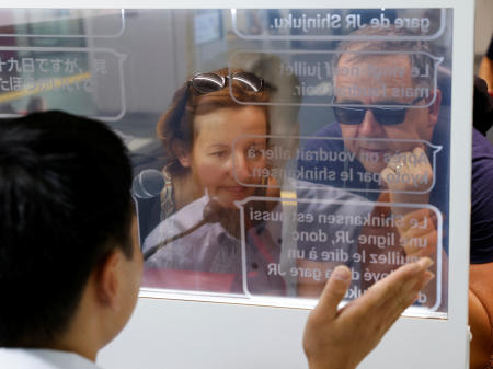 French tourists Isabelle and Marc Rigaud use an automated translation window at the Seibu-Shinjuku station in Tokyo, Japan, July 26, 2023. (Reuters)