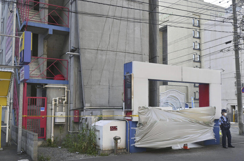 This shows a hotel where the headless body of a man was found in Sapporo, northern Japan on July 8, 2023. Japanese police said Tuesday, July 25 they have arrested a woman and her father in a bizarre beheading case in a popular night entertainment district in Japan's northern city of Sapporo, where the headless man was found in a hotel room three weeks ago. (Kyodo News via AP)