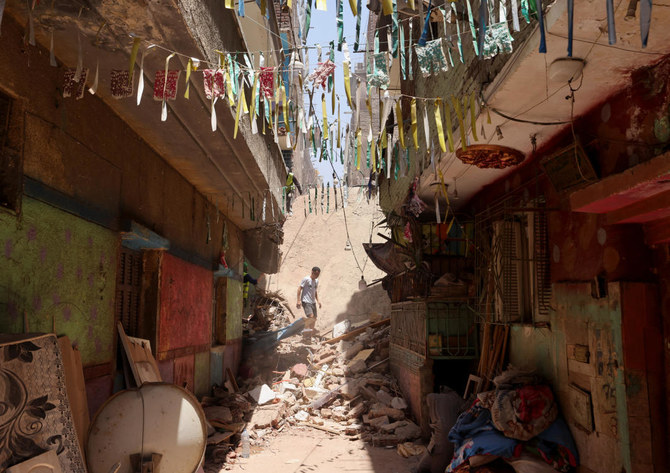 Egyptian emergency and rescue personnel search for survivors in the rubble of a five-story apartment building that collapsed, leaving several people dead, according to authorities, in Hadaeq Al-Qubbah neighborhood, in Cairo, Egypt, July 17, 2023. (Reuters)