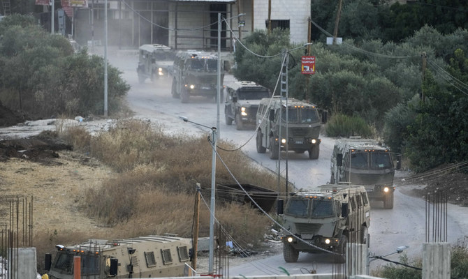 A convoy of army vehicles is seen during a military raid in the Jenin refugee camp in the occupied West Bank, July 4, 2023. (AP)