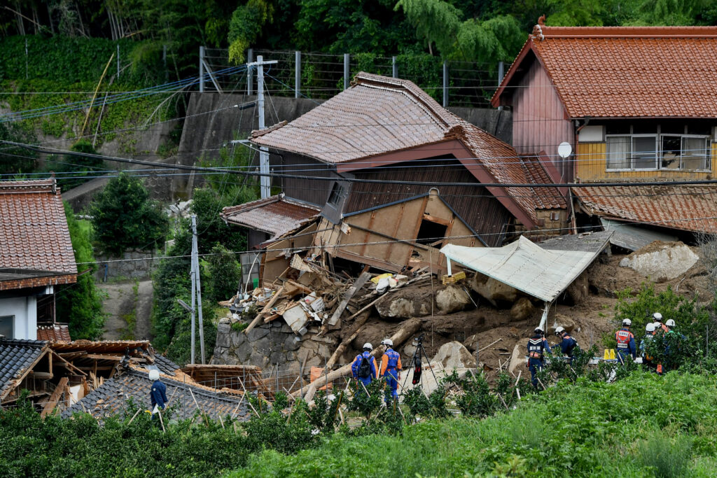 Rescue teams gather at the site of a landslide in Karatsu City, Saga prefecture on July 11, 2023, a day after heavy rains hit wide areas of Kyushu island. (AFP)