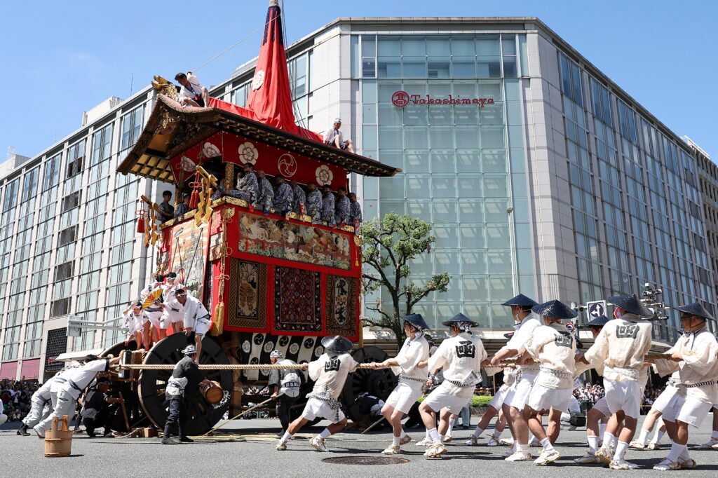 Participants pull a giant float through the streets of Kyoto during the month-long Gion Festival on July 17, 2023 (AFP). 