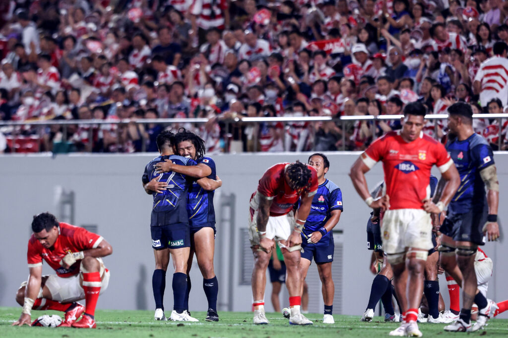 Japan's Rikiya Matsuda (2L) embraces Shota Horie (3L) after their win against Tonga during the international rugby union match between Japan and Tonga in Osaka (AFP). 