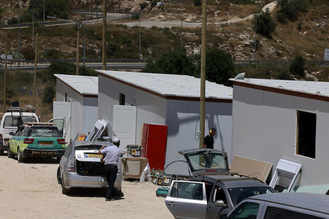 Above, Israeli settlers construct a new outpost near the settlement of Ma’ale Levona in the occupied West Bank on June 25, 2023. Civil society groups say the database is an important tool prompt companies to rethink their activities in the occupied territories. (AFP)