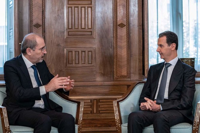 A handout picture released by the official Syrian Arab News Agency (SANA) shows Syria's President Bashar al-Assad (R) meeting with Jordan's Foreign Minister Ayman Safadi in Damascus on July 3. (AFP/Handout/SANA)