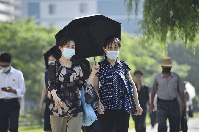 Pedestrians walk along Mirae Scientists' Street in Pyongyang on June 16, 2023. (AFP)