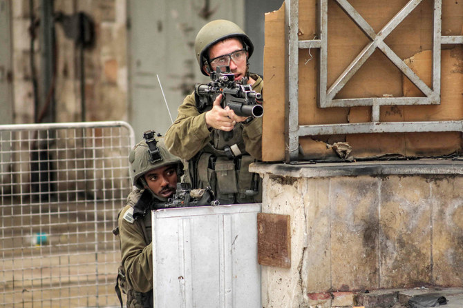 Israeli soldiers take aim during clashes in the centre of Hebron in the occupied West Bank on July 4, 2023. (AFP)