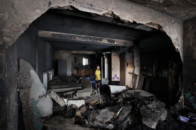 A boy checks the damage inside a house in the occupied West Bank Jenin refugee camp on July 6, 2023, following a large-scale Israeli military operation. (AFP)