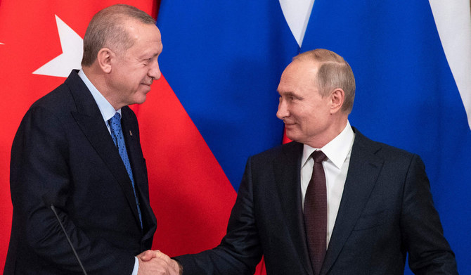 In this file photo taken on March 05, 2020 Russian President Vladimir Putin and his Turkish counterpart Recep Tayyip Erdogan shake hands at the end of a joint press statement following their talks at the Kremlin in Moscow. (AFP)