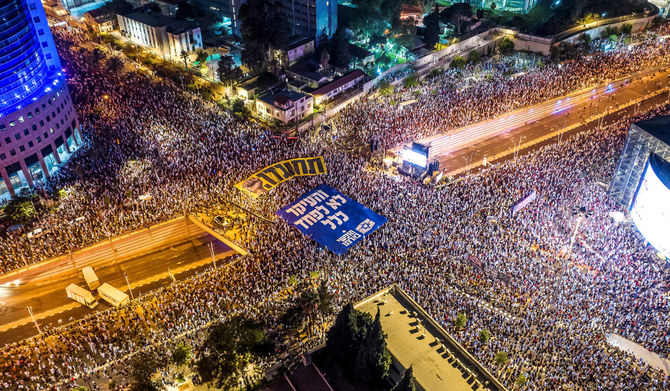 An aerial view shows protesters holding banners with the words in Hebrew