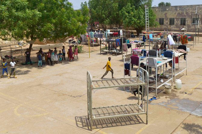 Displaced people who fled the ongoing violence by two rival Sudanese generals, gather in the courtyard of the university of al-Jazira, transformed into a makeshift shelter, in al-Hasaheisa south of Khartoum on July 8,2023. (AFP)