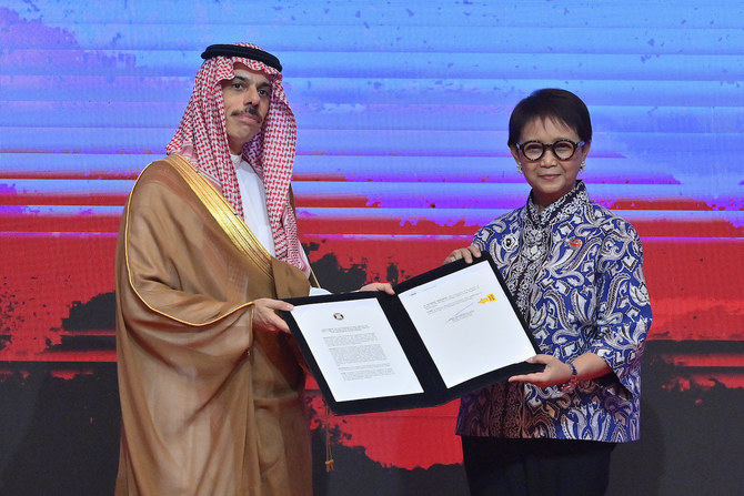Saudi FM Prince Faisal bin Farhan poses with his Indonesian counterpart, Retno Marsudi, after signing the Treaty of Amity and Cooperation with ASEAN in Jakarta on July 12, 2023. (Indonesian Ministry of Foreign Affairs)