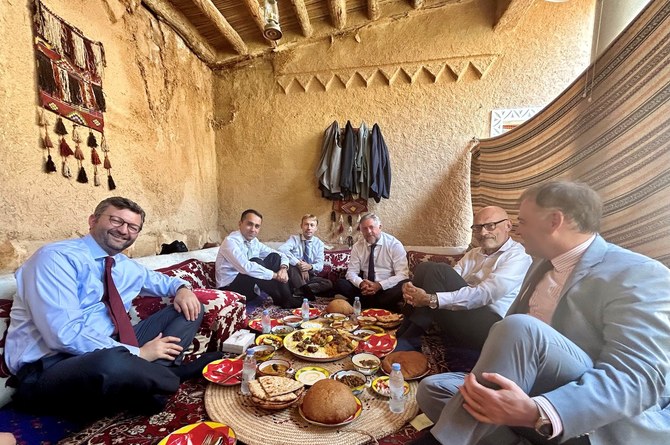 The first EU special representative for the Gulf region, Luigi Di Maio, samples Saudi delicacies in the traditional manner in Riyadh. (Supplied)
