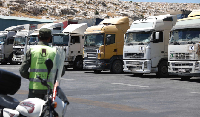 A convoy of trucks carrying humanitarian aid is seen parked after crossing the Syrian Bab al-Hawa border crossing with Turkiye, on July 10, 2023. (AFP)