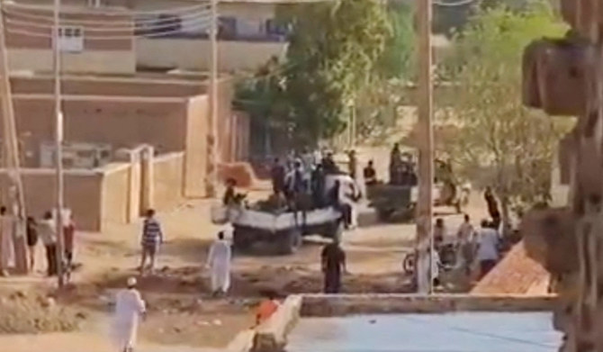 This frame grab taken from AFPTV video footage shows Sudanese armed forces driving military vehicles through a street in Omdurman on July 13, 2023. (AFP)