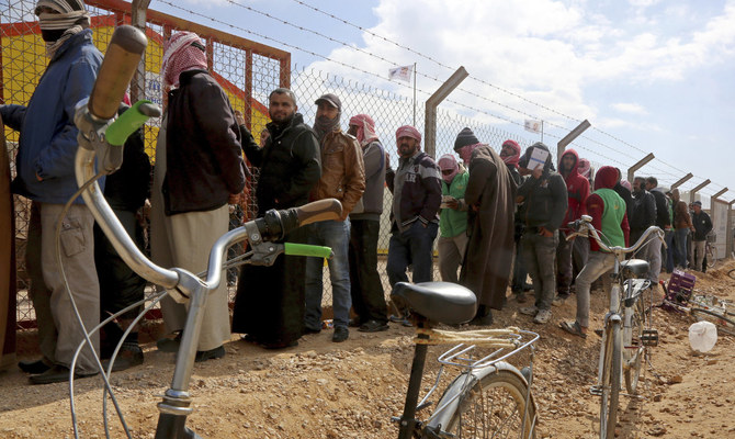 Syrian refugees line up to register their names at an employment office, at the Azraq Refugee Camp, 100 kilometers east of Amman, Jordan. (AP/File)