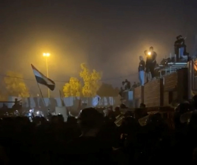 A screen grab obtained from a social media video shows protesters gathered near the Swedish embassy on July 20, 2023, after it was stormed and set on fire ahead of an expected burning of the Muslim holy book in Stockholm, Sweden. (Muhannad Al-Azzawi/via REUTERS)