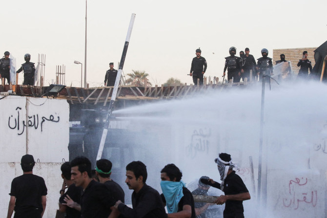 Firefighters spray water on the Swedish embassy in Baghdad to put out a fire as protesters gather on July 20, 2023. (REUTERS)