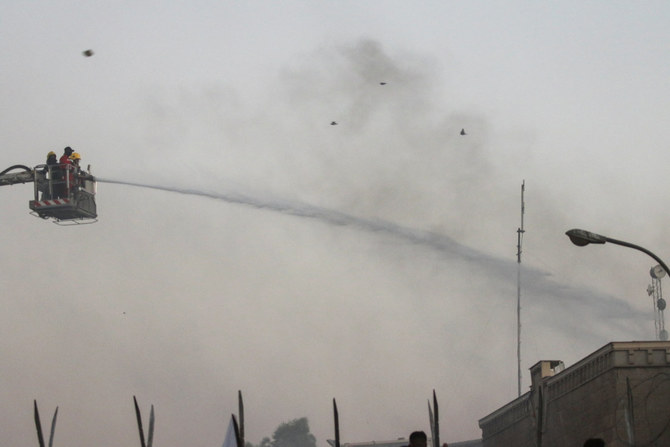 Firefighters spray water on the Swedish embassy in Baghdad to put out a fire as protesters gather on July 20, 2023. (REUTERS)
