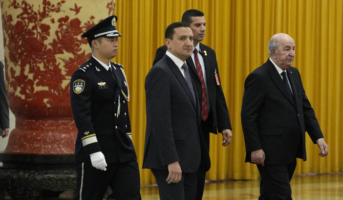 Algerian President Abdelmadjid Tebboune, right, arrives for talks with Chinese Premier Li Qiang, unseen, at the Great Hall of the People in Beijing, Wednesday, July 19, 2023. (AP)