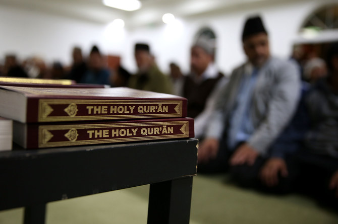 Copies of the Quran sit on a table as Muslim men pray at Baitul Hameed Mosque on Dec. 3, 2015 in Chino, California. (AFP)