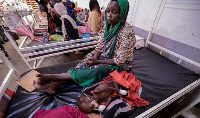 Fadila Ahmad, a Sudanese woman who fled the conflict in Darfur, sits beside her child Abdel Salam, who is suffering from malnutrition, at Medecins Sans Frontieres mission hospital in Adre, Chad. (Reuters)
