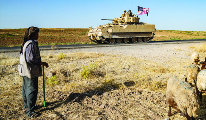 US soldiers patrol the countryside of Al-Malikiya town in Syria’s northeastern Hasakah province. (AFP)