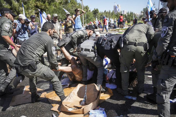 Police disperse demonstrators blocking the road leading to the Knesset, Israel’s parliament, during a protest in Jerusalem on July 24, 2023. (AP)