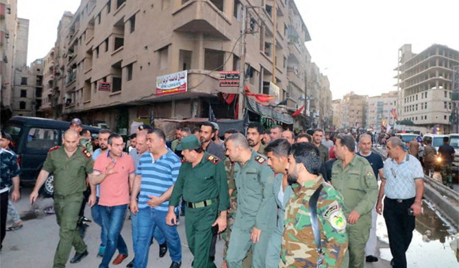 People and internal security members inspect the site of a bomb blast, outside the Sayeda Zeinab shrine city, south of the Syrian capital Damascus, Syria July 27, 2023. (REUTERS)