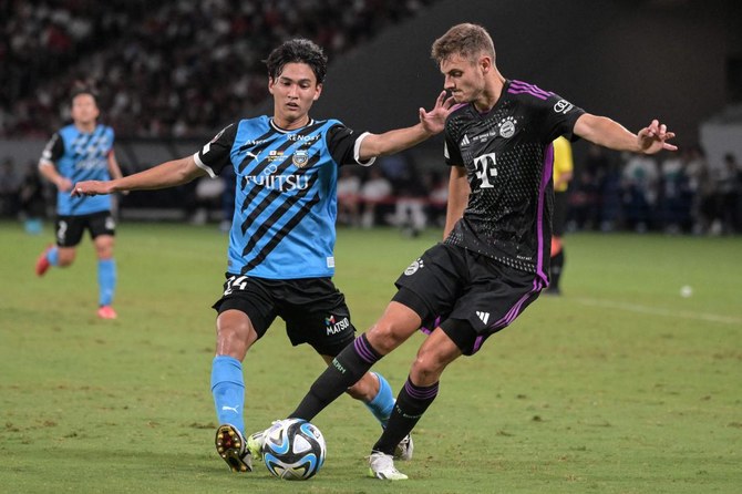 Bayern Munich’s Josip Stanisic is challenged by Kawasaki Frontale’s Toya Myogan during their friendly match at the National Stadium in Tokyo on July 29, 2023. (AFP)