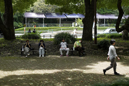 People rest in shade at a park in Tokyo, Friday, July 7, 2023. (AP)