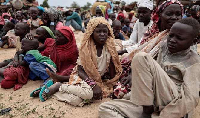 Sudanese family, who fled the conflict, sit beside their belongings upon crossing the border between Sudan and Chad. (Reuters)