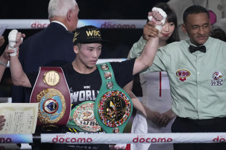 Naoya Inoue of Japan (left) celebrates after beating Stephen Fulton of the US in the eighth round of a boxing match for the unified WBC and WBO super-bantamweight world titles in Tokyo, Tuesday, July 25, 2023. (AP)