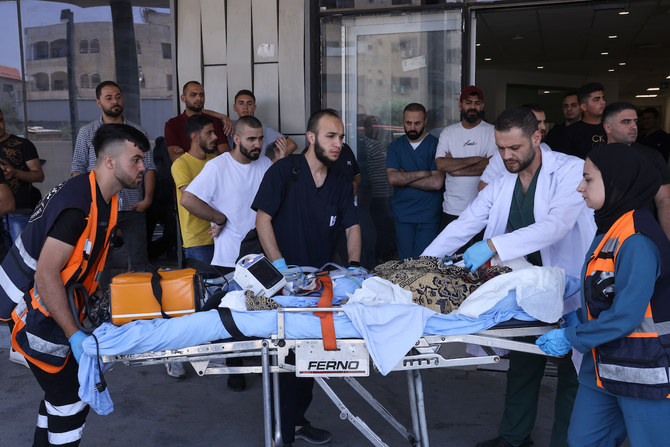Palestinian medics transport an injured person into a hospital during an Israeli military operation in Jenin city in the occupied West Bank. (File/AFP)