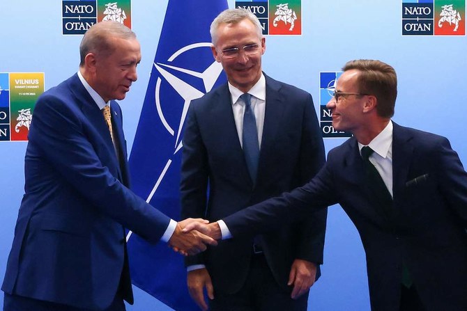 Turkish President Tayyip Erdogan (L) and Swedish Prime Minister Ulf Kristersson shake hands in front of NATO Secretary-General Jens Stoltenberg prior to their meeting, on the eve of a NATO summit, in Vilnius on July 10, 2023. (AFP)