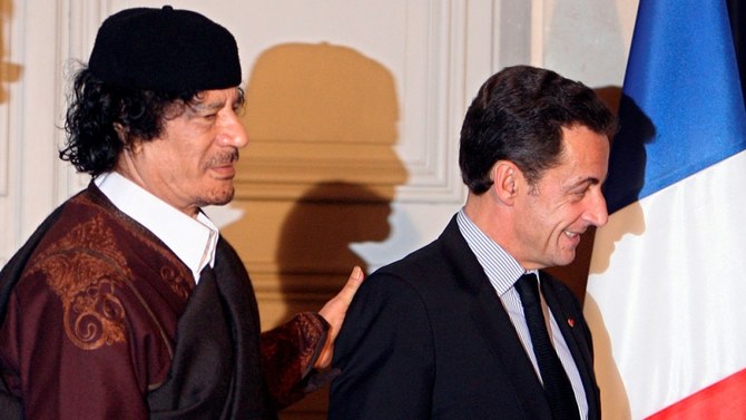 Muammar Gaddafi and Nicolas Sarkozy. (Reuters)