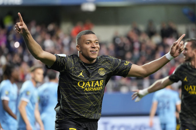 PSG's Kylian Mbappe celebrates after scoring his side's opening goal during the French League One soccer match between Troyes and Paris Saint Germain, at the Stade de l'Aube, in Troyes, France, Sunday, May 7, 2023. (AP)