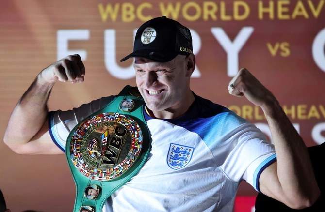 WBC heavyweight boxing champion Tyson Fury poses with his championship belt after the official weigh-in for his fight against Derek Chisora, London, Britain, Dec. 2, 2022. (AP Photo)