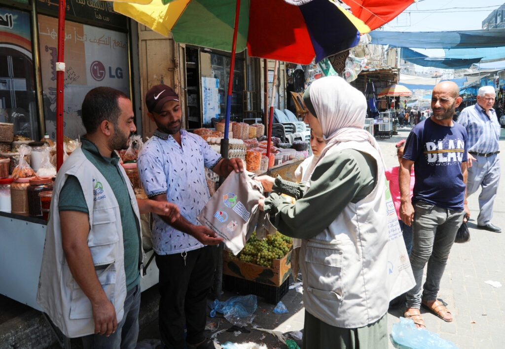 Palestinian team distribute bags made of cloth to urge residents to avoid the use of plastic bags, which are in extreme use in the enclave, and educate them of the risks as a step in a new environment-friendly campaign in Gaza called 