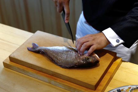 Kazuyuki Tanioka prepares a sea bream sourced within China, during an interview with Reuters, in Beijing, China July 25, 2023. (Reuters)