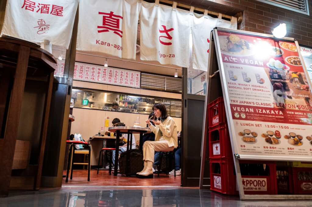 Customers seated while dining at the Vegan Izakaya Masaka restaurant in the Shibuya area of Tokyo. (AFP)