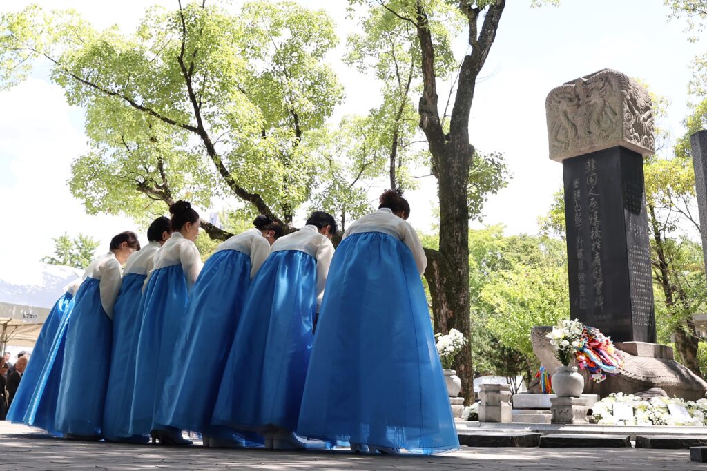 Attendees lay wreaths during the remembrance service on August 5. (AFP)